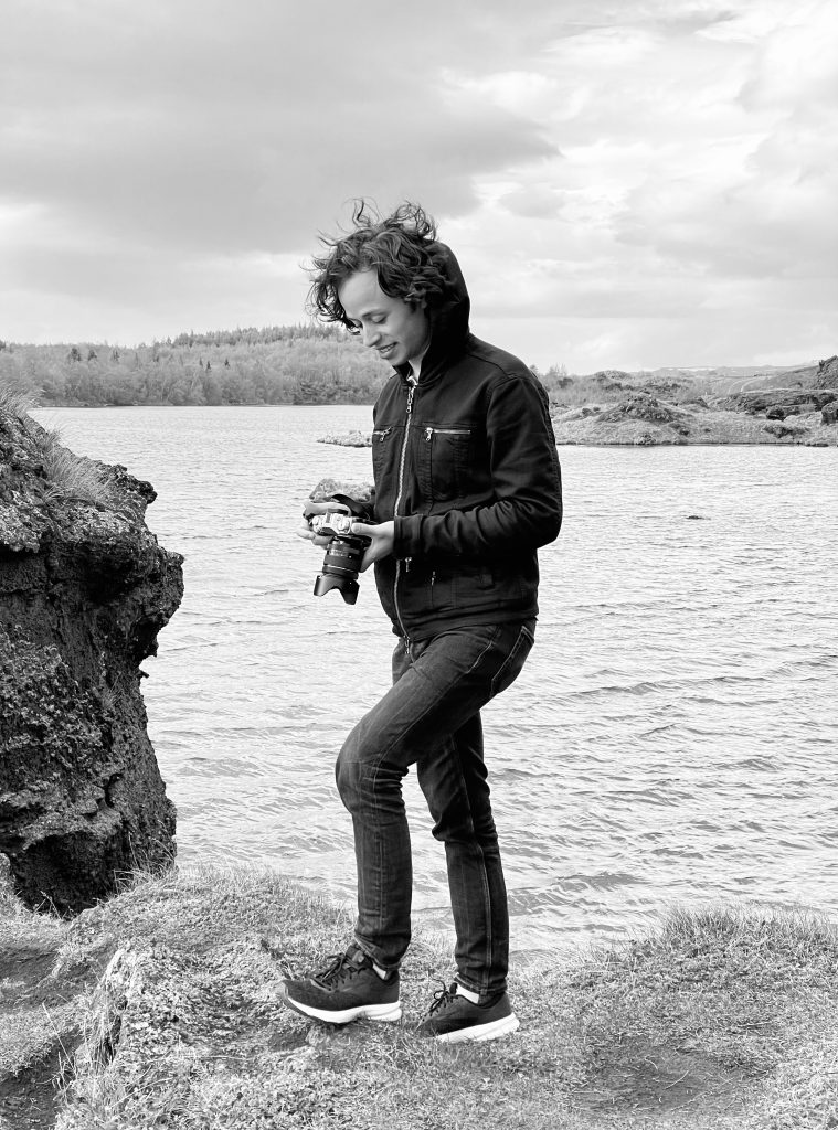 Photo of Kyle Tunis holding a camera